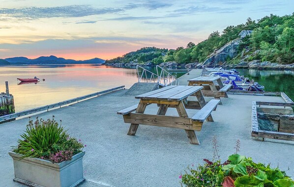 Relax by the serene lake with a dock offering picnic tables and benches.