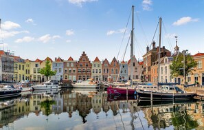 A marina with boats docked, surrounded by historic buildings with varied architectural styles. - Nice home in Heinkenszand with WiFi (Heinkenszand)