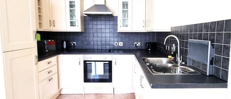 Junior Apartment | Private kitchen | Full-size fridge, microwave, oven, stovetop