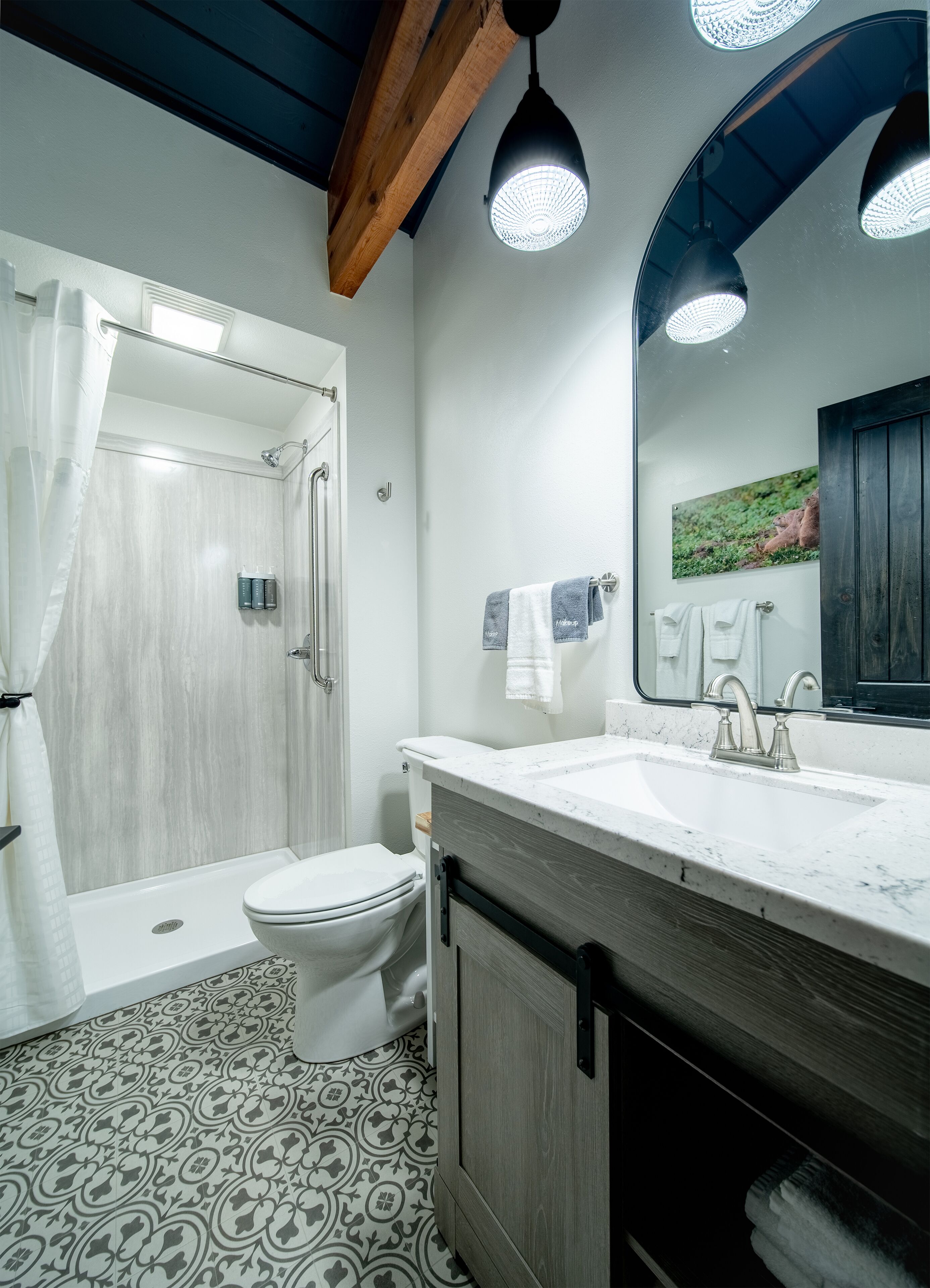 A modern bathroom with a shower, toilet, and sink.