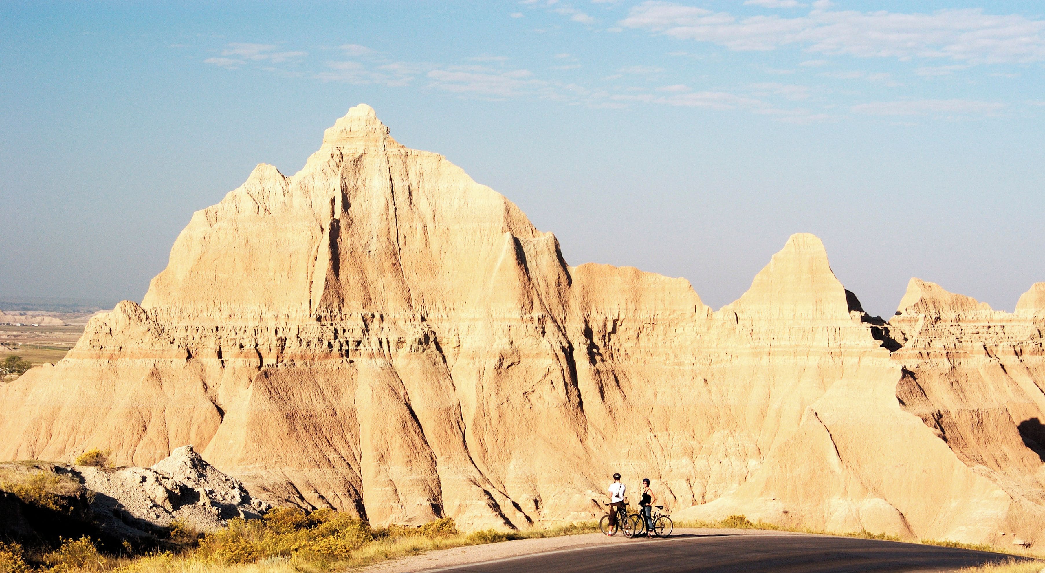 A road with cyclists in Badlands National Park.