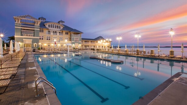 A large hotel with a swimming pool and waterfront views.