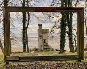 A framed view of a castle ruin with a sign reading "Appleby Park, Ryd". - Arden Villa With Sea Views (Ryde)