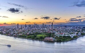 Panoramic city view with a body of water and a variety of buildings.