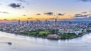 A cityscape with a waterfront, high-rise buildings, and a mix of residential and commercial areas.