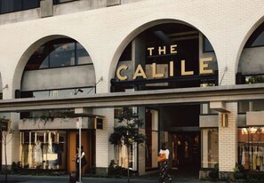 Welcome to The Calile, a modern building with a brick and glass exterior, featuring storefronts on the ground level.