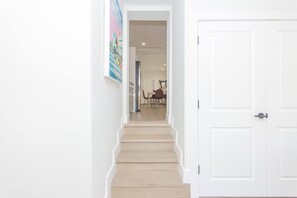 A staircase leading to a room with a white door. - Renovated 3 bedroom house with outdoor space  (Miami)
