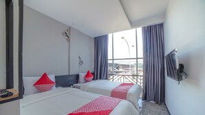 A hotel room with two beds, a TV, and a window with curtains. - Capital O 90447 Kardopa Hotel Megapark (Medan)