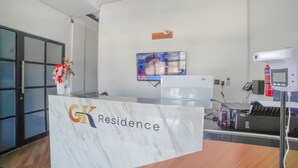 A reception desk with a marble top and a logo that reads "GK Residence". - Capital O 90447 Kardopa Hotel Megapark (Medan)