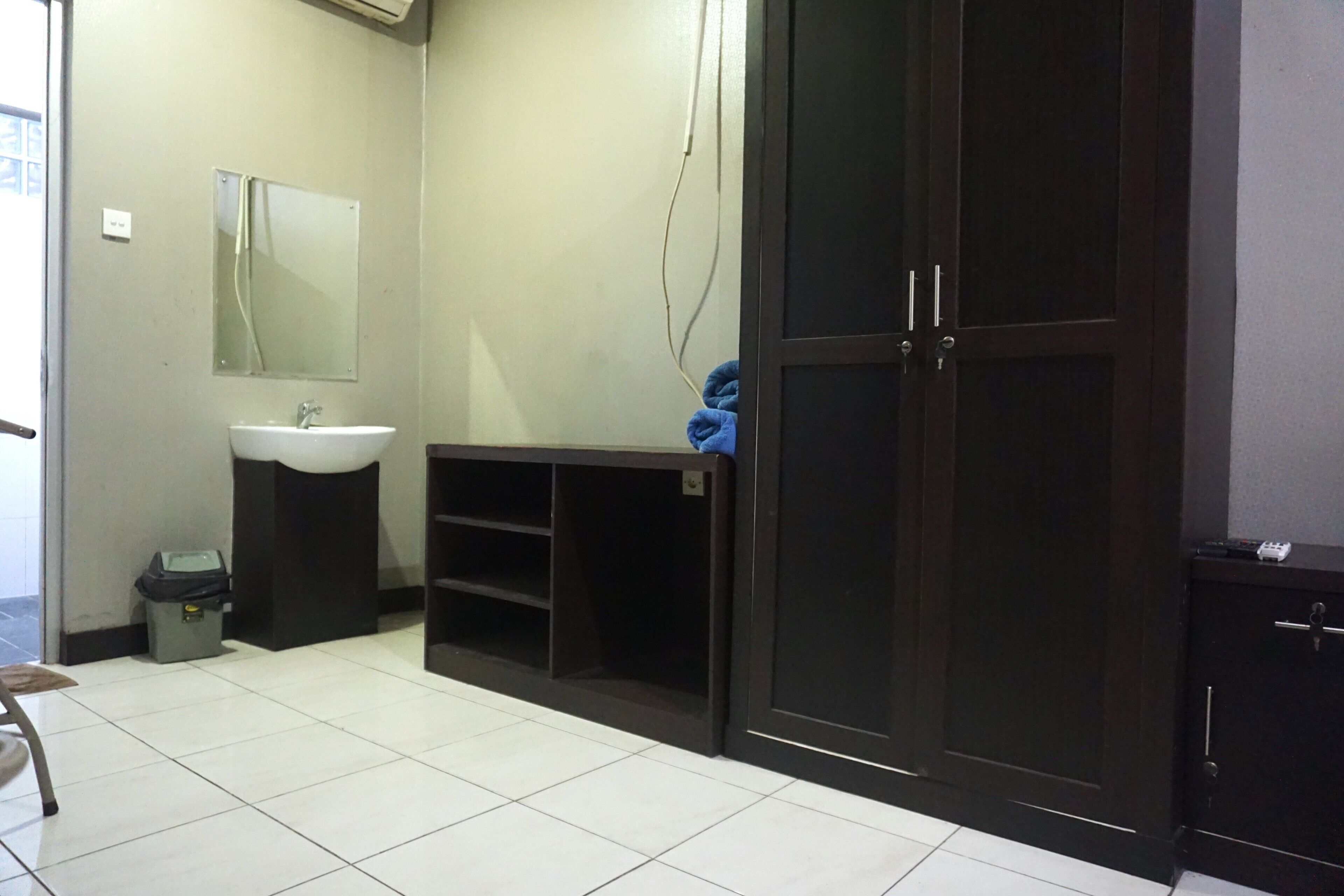 A bathroom with a sink, mirror, and dark cabinets.