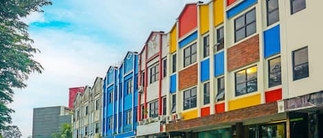 A row of colorful buildings with multiple stories, featuring a mix of commercial and residential spaces.