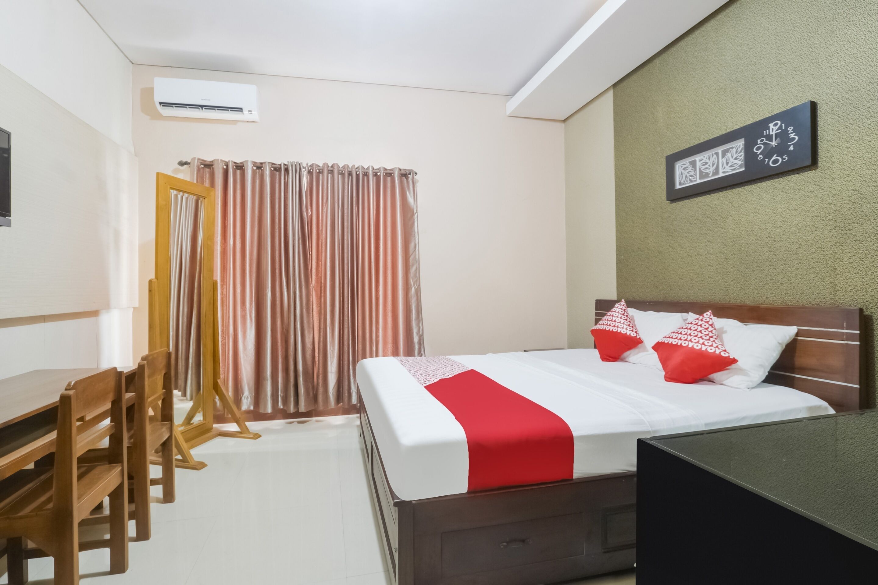 A hotel room with a bed, a desk, and a chair.