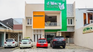A building with a green sign reading "d'Ware H.o.m.e Stay".