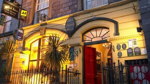 A building with a red door, multiple windows, and a sign reading "Old Bank House." - Old Bank House Kinsale (Kinsale)