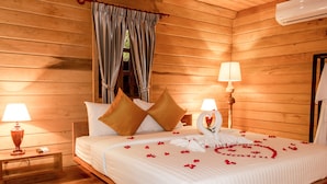A wooden room with a bed, two bedside lamps, and a window with curtains. - Angkor Heart Bungalow- Private Pool (Siem Reap)