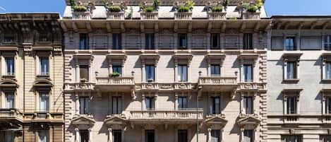 A multi-story building with a classical architectural style, featuring symmetrical balconies and large windows.