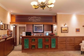 A hotel reception desk with a sign indicating 'HOTEL PTUJ SINCE 1890'. - Hotel Mitra (Ptuj)