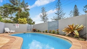 A swimming pool with a tiled deck, a white lounge chair, and a no diving sign. - Beachfront, ocean views, private rooftop terrace with spa, pool, walk to beach (Marcoola)