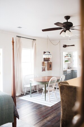 Enjoy meals in this dining area with a wooden table and comfortable chairs.