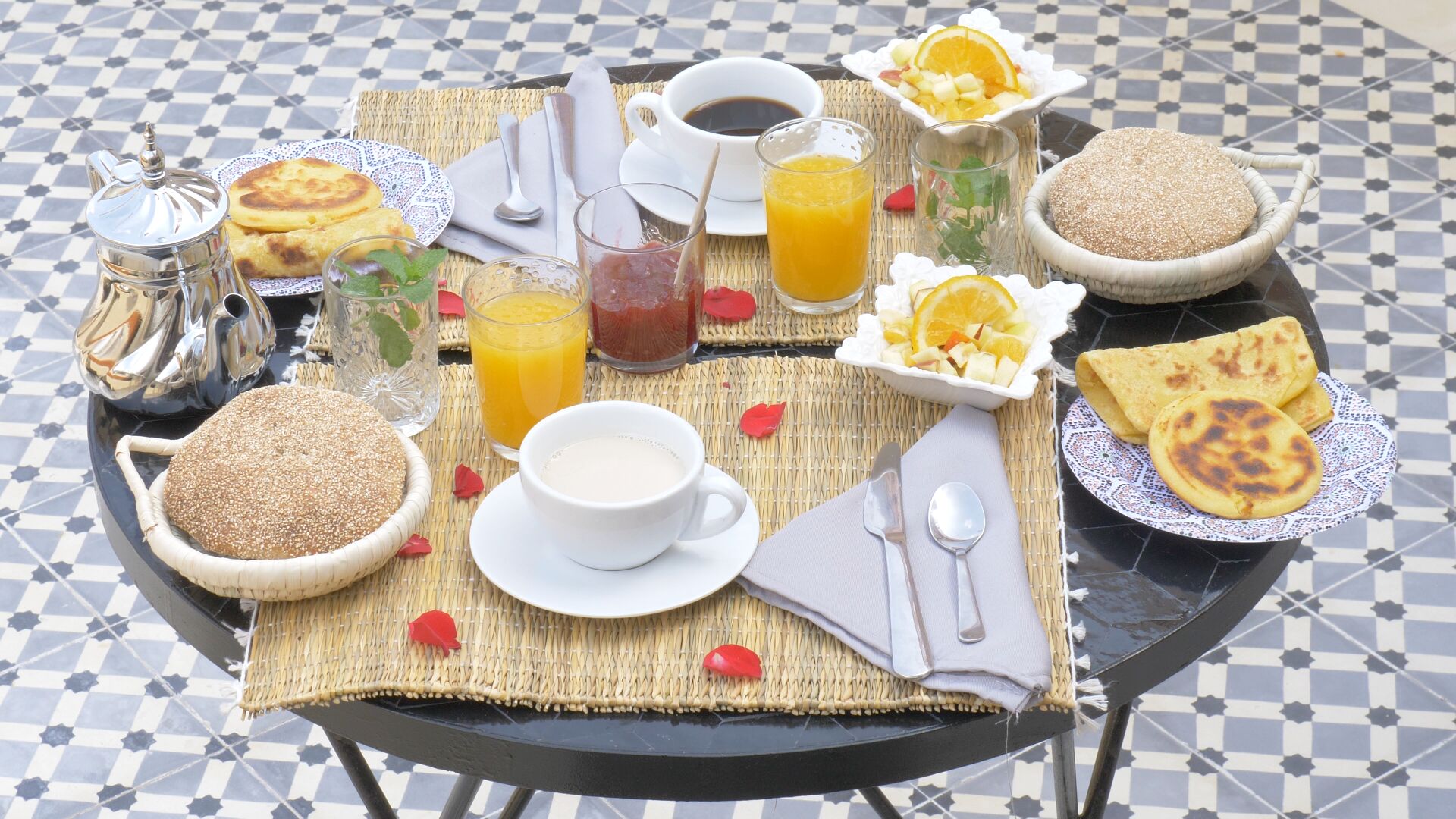 Una escena de desayuno con una variedad de alimentos y bebidas sobre una mesa.