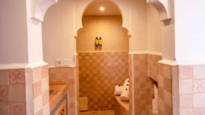 A bathroom with a checkered tile wall, a sink, and a towel rack. - Riad Dar Nejma & Spa (Marrakech)