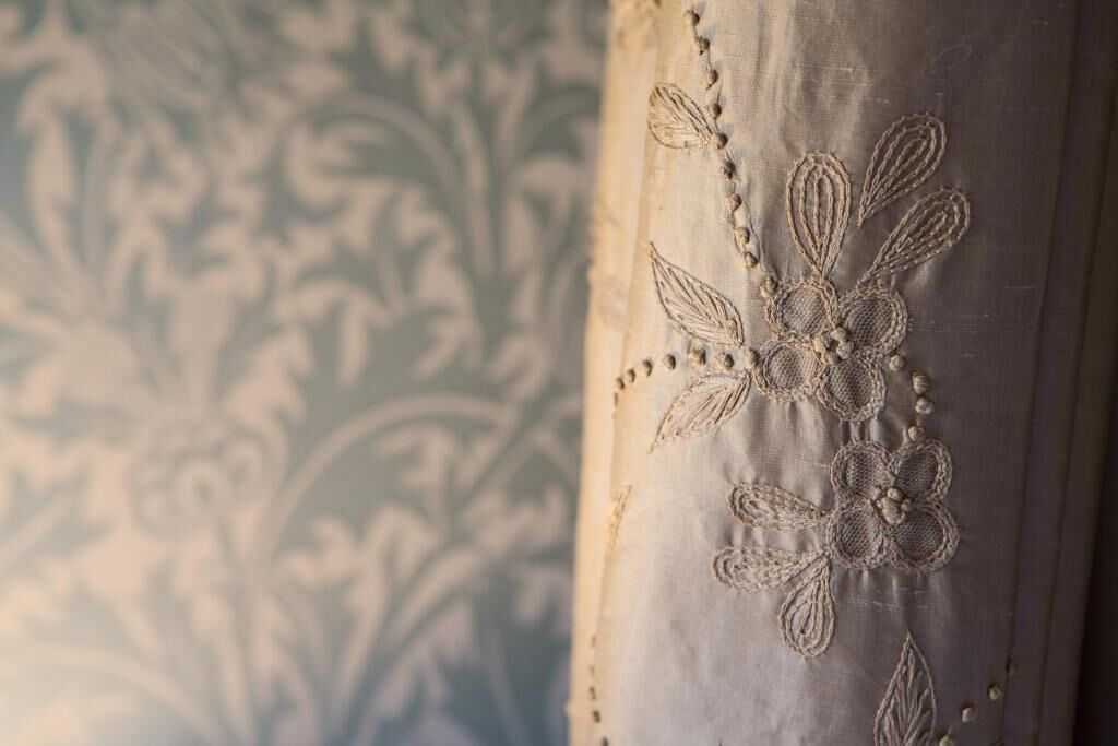 A close-up of a fabric with floral embroidery.