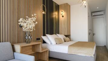 A modern bedroom with a bed, bedside table, and a decorative vase.