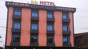 A hotel with a sign reading "LIEBE HOTEL" and a reception area with a bar. - LIEBE HOTEL (Yaoundé)