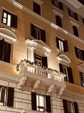 A multi-story building with classical architectural features, including ornate balconies and decorative moldings. - DolceVitaSuite (Rome)