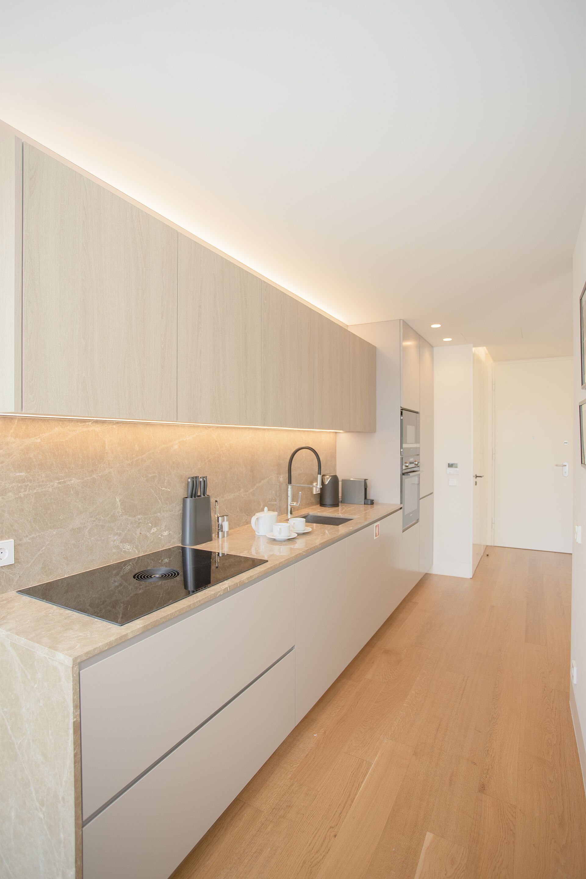 A modern kitchen with a built-in stove, a sink, and a countertop.