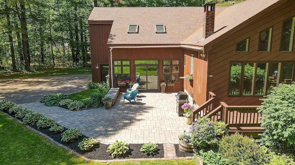 A two-story wooden house with a covered patio, a wooden deck, and a large windowed porch. - Sebago Pine Lodge +Bonus Yurt! (Windham)