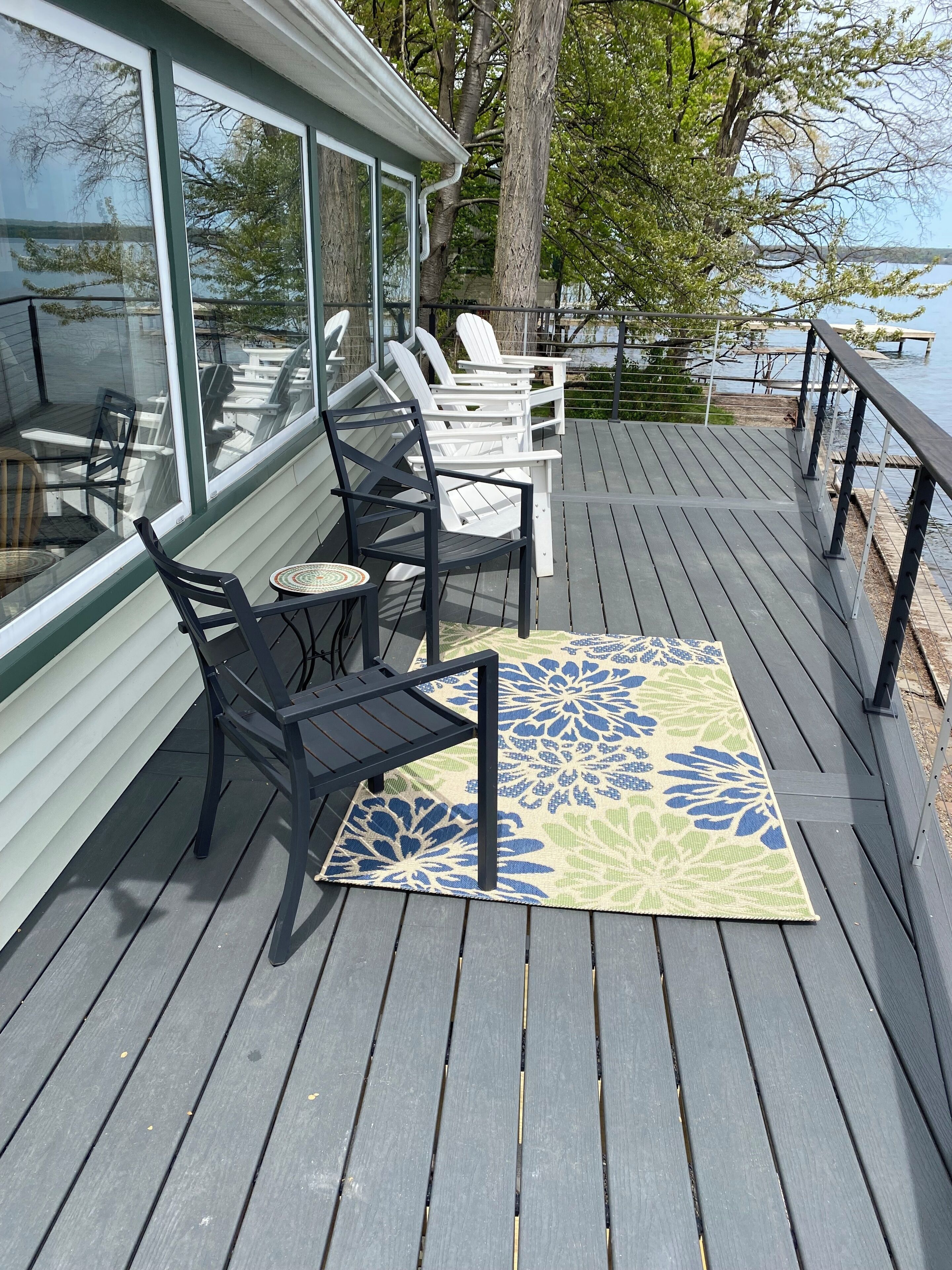 A deck with outdoor seating and a view of the lake.