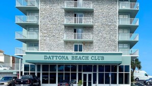 A multi-story building with balconies and a sign reading "Daytona Beach Club". - Ocean View Studio • Steps to Beach (Daytona Beach)