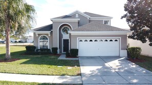 A single-story house with a garage, a front door, and a small porch.