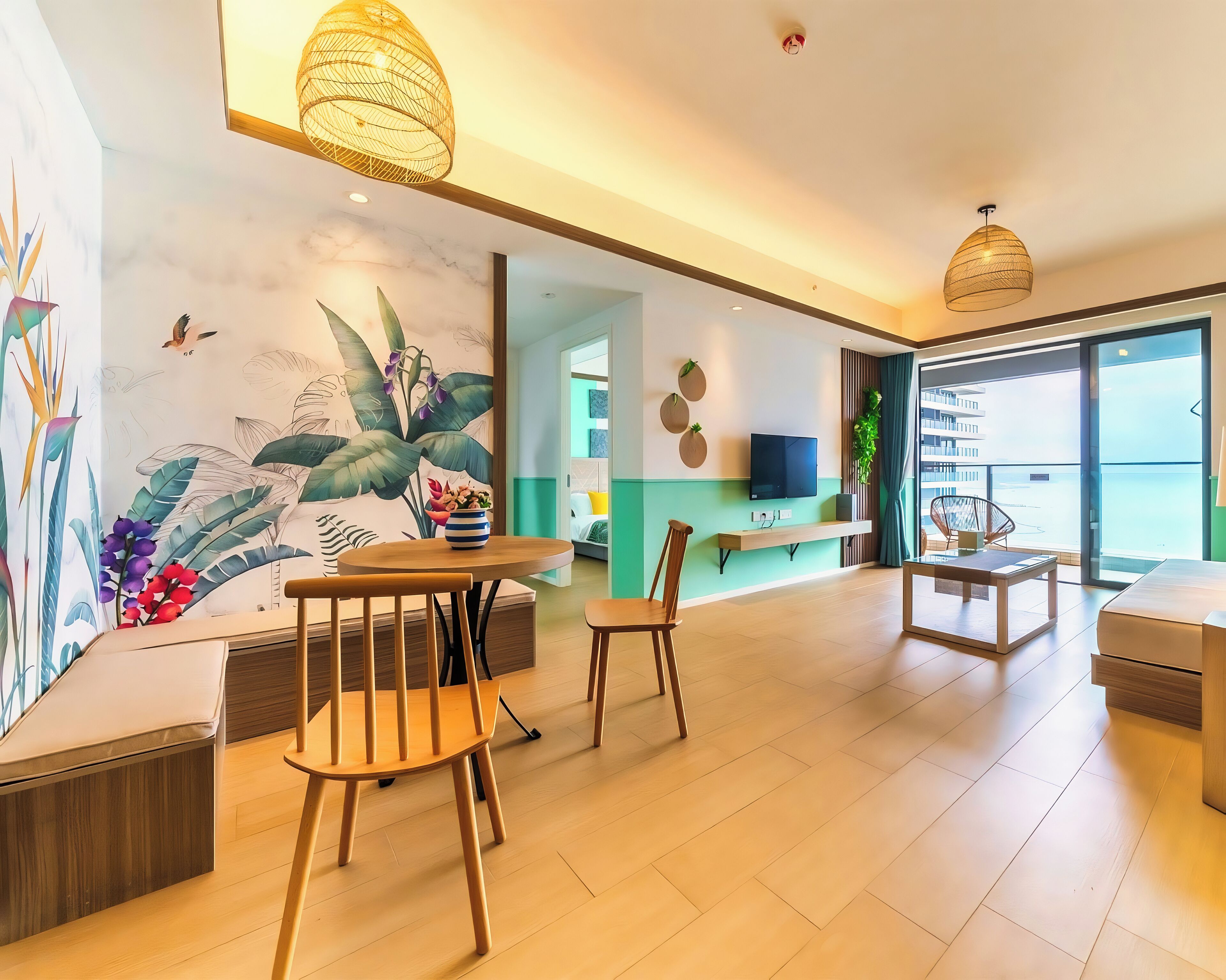A modern living room with a dining area, a TV mounted on the wall, and a large window offering a view of the city.