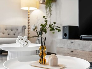Relax in this stylish living room with a tufted sofa, coffee table, and a statement plant.