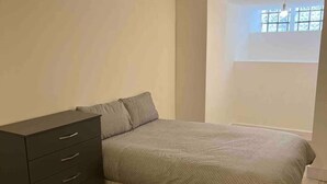 A bedroom with a bed, a dresser, and a window. - Spacious Luxury 2 Bedroom Apartment, Station 1min (London)