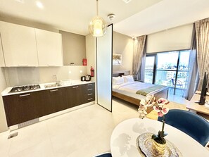 Apartment (0 Bedroom) | Private kitchen | Microwave, oven, cookware/dishes/utensils, freezer - Stunning New Studio With Balcony in Park View JVC (Dubai)