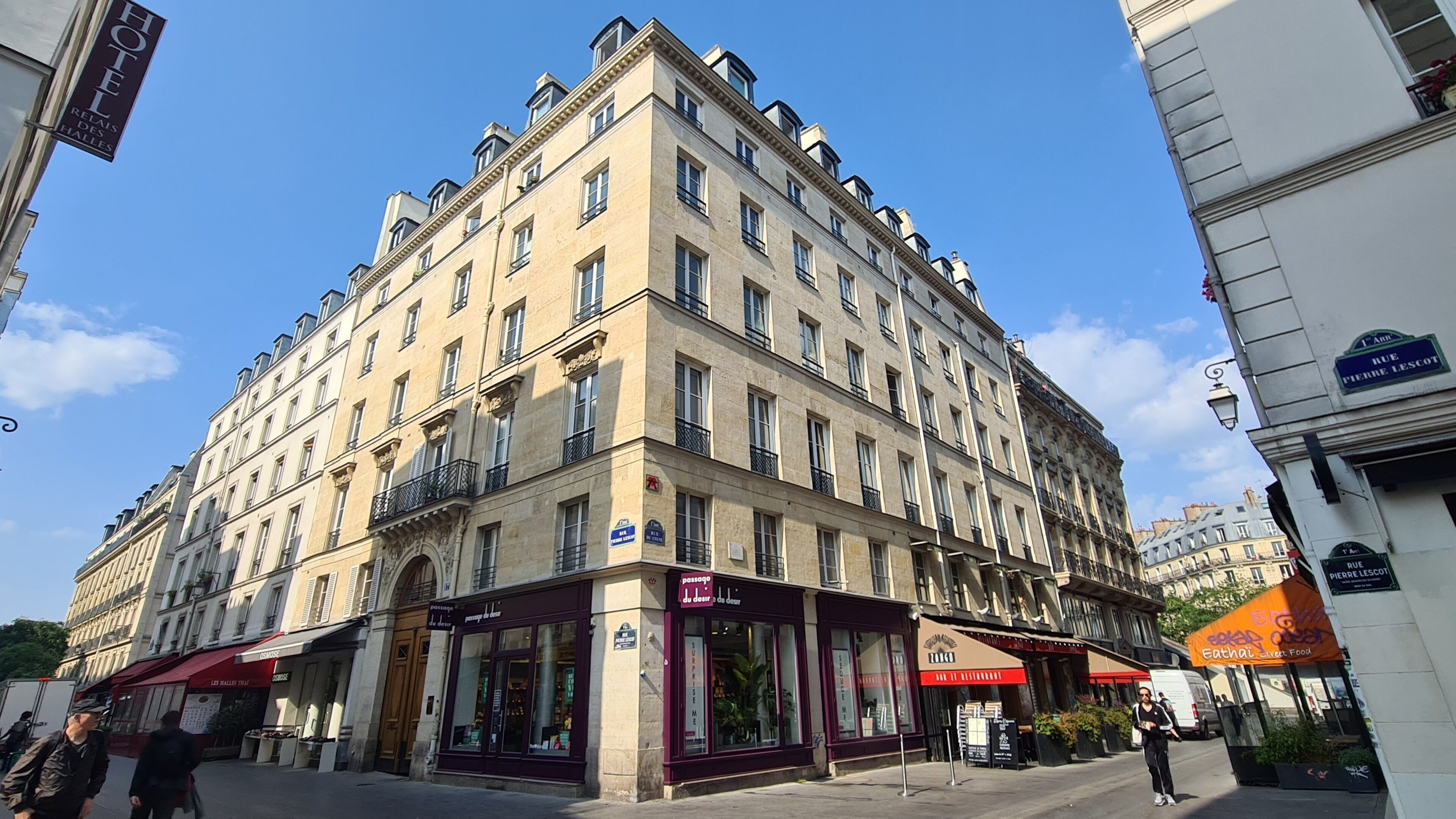 A multi-story hotel with a classic architectural style, featuring a ground-level restaurant and a visible entrance.