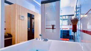 A modern bathroom with a large bathtub, wooden panel walls, and a glass shower enclosure. - Private Seaside Villa Sleeps 10 With Infinity Pool (Zupa dubrovacka)