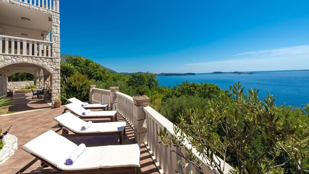 A balcony with sun loungers overlooking a sea view. - Private Seaside Villa Sleeps 10 With Infinity Pool (Zupa dubrovacka)