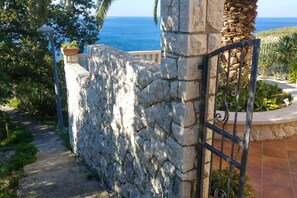 Stroll through the beautifully landscaped grounds, leading to a serene ocean view.