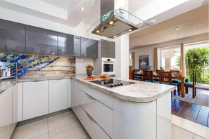 Enjoy cooking in the well-equipped kitchen with a central island, stove, and ample counter space.