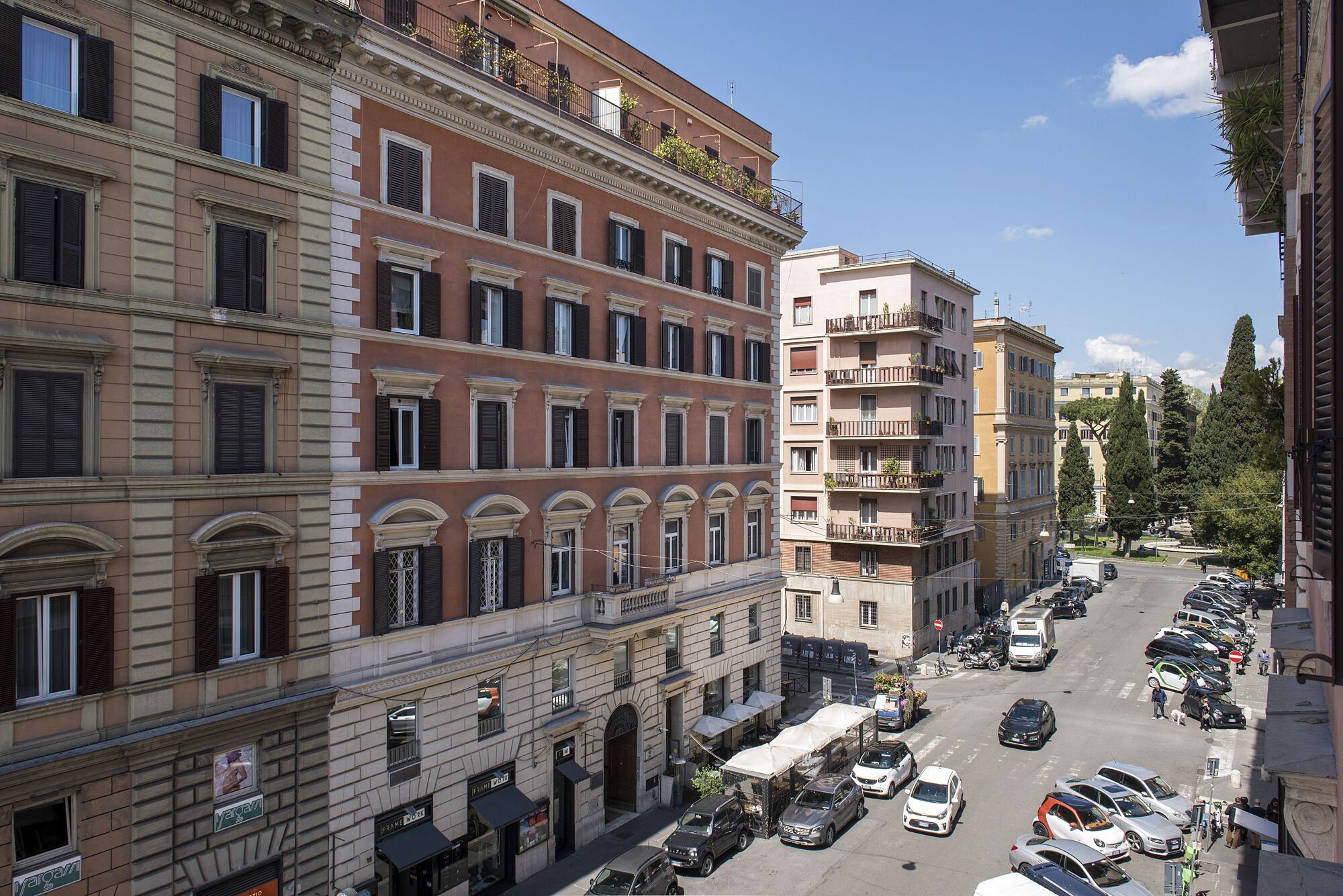 A multi-story building with a classic architectural style, featuring balconies and large windows.