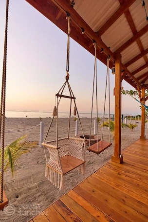 On the beach, sun loungers, beach towels. Spectacular oceanfront home