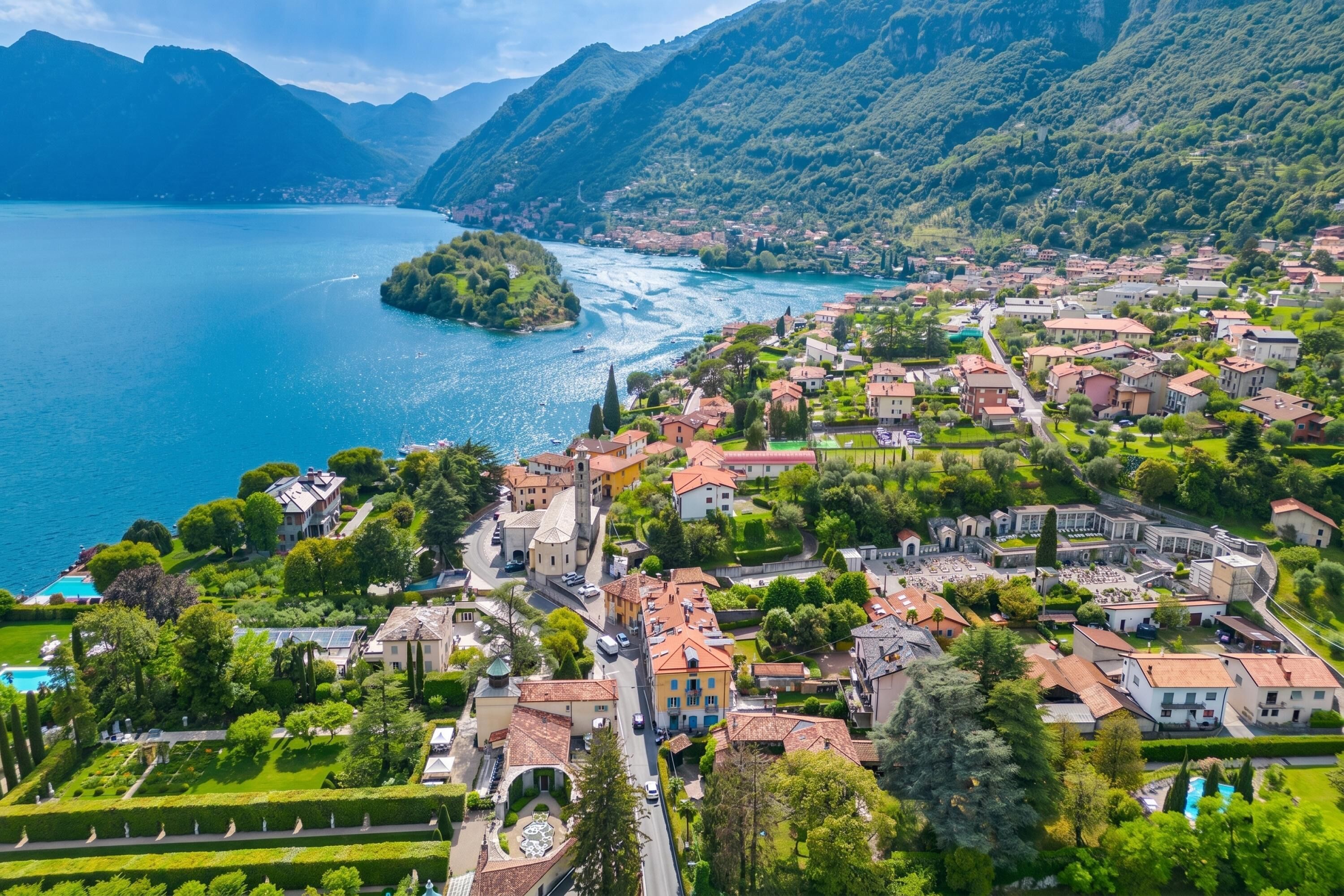 A coastal town with a river, surrounded by mountains, featuring historic buildings and well-maintained gardens.