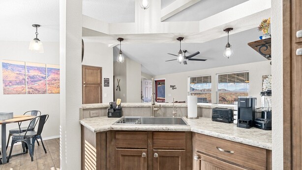 A modern kitchen with a large island, built-in appliances, and a dining area with a table and chairs. - Bayview Beauty! Private River access and mountain views! (Parker)