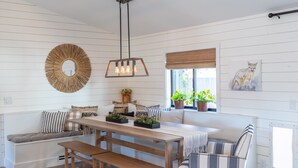 A cozy seating area with a bench, a table, and a window with plants. - Castle Rock 95, 4brs, Community launch, Riverfront park (Parker)