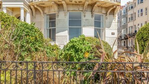 A historic building with ornate architectural details, including a decorative balcony and intricate facade patterns.