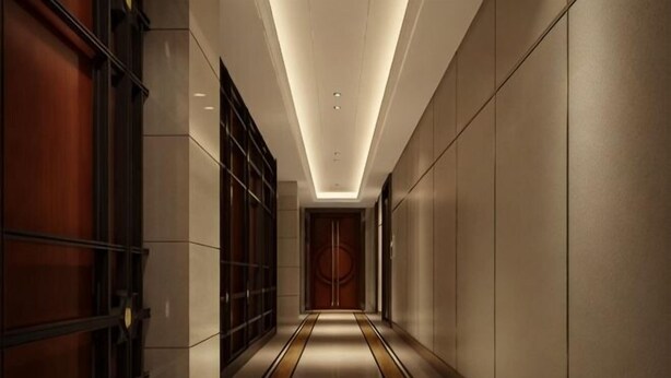 A corridor with a wooden door at the end, tiled walls, and a patterned floor. - Century Yuan International hotel(Jiangyan,Taizhou) (Taizhou)